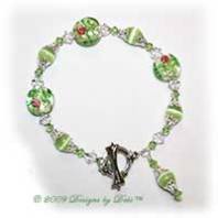 Designs by Debi Handmade Jewelry Lime Green Cat's Eye, Glass Coin Beads with Roses and Swarovski Crystal AB and Peridot Bicones Bracelet with a Silver and Crystal Square Toggle Clasp