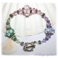Designs by Debi Handmade Jewelry Lavender, Pink and Mint Green Handmade Lampwork Bracelet with Swarovski Crystal Violet, Rosaline and Chrysolite Bicones, Sterling Silver Plated Flower Spacers, Caps and Swarovski Toggle Clasp ~ OOAK