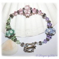 Designs by Debi Handmade Jewelry Lavender, Pink and Mint Green Handmade Lampwork Bracelet with Swarovski Crystal Violet, Rosaline and Chrysolite Bicones, Sterling Silver Plated Flower Spacers, Caps and Swarovski Toggle Clasp ~ OOAK