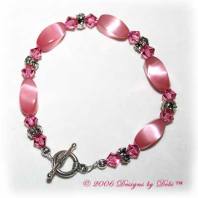 Designs by Debi Handmade Jewelry Pink Cat's Eye Twist Beads, Swarovski Crystal Rose Bicones and Silver Floral Rondelles Bracelet with a Silver Round Toggle Clasp
