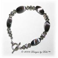 Designs by Debi Handmade Jewelry Gray Cat's Eye Twist Beads, Swarovski Crystal Black Diamond Bicones and Silver Floral Rondelles Bracelet with a Silver Round Toggle Clasp
