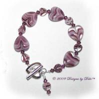 Designs by Debi Handmade Jewelry Purple Glass Hearts and Swarovski Crystal Amethyst Bicones Bracelet with a Silver Heart Toggle Clasp