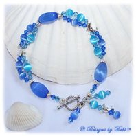 Designs by Debi Handmade Jewelry Dolphins Roaming the Ocean Sterling Silver Dolphins Bracelet with Blue and Aqua Cat's Eye Beads, Swarovski Crystal Sapphire and Aquamarine Bicones, Dangles and a Sterling Silver Twisted Rope Toggle Clasp
