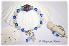 Designs by Debi Handmade Jewelry Aloha Collection Sterling Silver and Handmade Lampwork Bangle Bracelet and Anklet Set. Features a handmade etched blue bicone with pink hibiscus, etched white lampwork beads, sapphire blue swarovski bicone crystals, dangles, a flower clasp and matching anklet