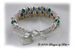Designs by Debi Handmade Jewelry 3 strand Keepsake Bracelet in the Karen Style Twist bead combination with Emerald (May), Amethyst (February) and Topaz (November) crystals, a heart toggle clasp and Grandma heart charm. Grandmother's or Nana's Bracelet