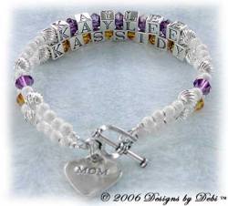 Designs by Debi Handmade Jewelry 2 strand Keepsake Bracelet in the Karen Style Twist and Stardust bead combination with Amethyst (February) and Topaz (November) crystals, a heart toggle clasp and Mom heart charm. Mother's Bracelet