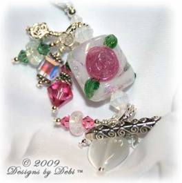 Roses on the Glistening Snow Handmade Bracelet made with artisan handmade lampwork beads, Bali silver, Swarovski crystal, and cat's eye with a toggle style clasp.