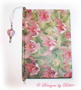 Sample photo of a Designs by Debi Handmade Jewelry ribbon slide style bookmark in use