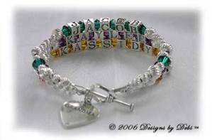 Designs byDebi Handmade Jewelry 3 strand Karen Style Bracelet in the Twist bead combination with Emerald (May), Amethyst (February) and Topaz (November) crystals, a heart toggle clasp and Grandma heart charm.