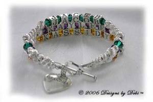 Designs by Debi Handmade Jewelry 3 strand Karen Style Bracelet in the Twist bead combination with Emerald (May), Amethyst (February) and Topaz (November) crystals, a heart toggle clasp and Grandma heart charm.