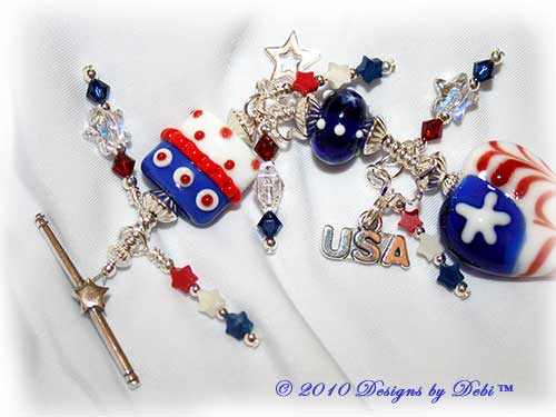Designs by Debi Jewelry for Charity Piece for June 2010 to raise money for Soldiers' Angels. A one-of-a-kind artisan handmade bracelet with red, white and blue flag motif handmade glass beads, swarovski crystal siam and dark sapphire bicones, Swarovski Crystal and Crystal AB stars, red, white and blue howlite stars, sterling silver star, heart-shaped flag and USA charms and a sterling silver star toggle clasp. OOAK