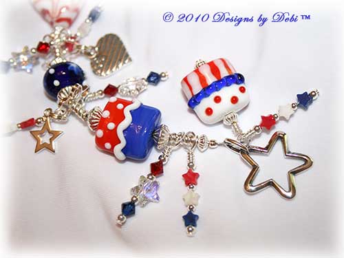 Designs by Debi Jewelry for Charity Piece for June 2010 to raise money for Soldiers' Angels. A one-of-a-kind artisan handmade bracelet with red, white and blue flag motif handmade glass beads, swarovski crystal siam and dark sapphire bicones, Swarovski Crystal and Crystal AB stars, red, white and blue howlite stars, sterling silver star, heart-shaped flag and USA charms and a sterling silver star toggle clasp. OOAK