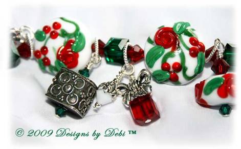 The Perfect Christmas Present Handmade Bracelet made with artisan handmade lampwork beads, Bali silver, Swarovski crystal, and cat's eye with a Bali toggle style clasp. Close-up.