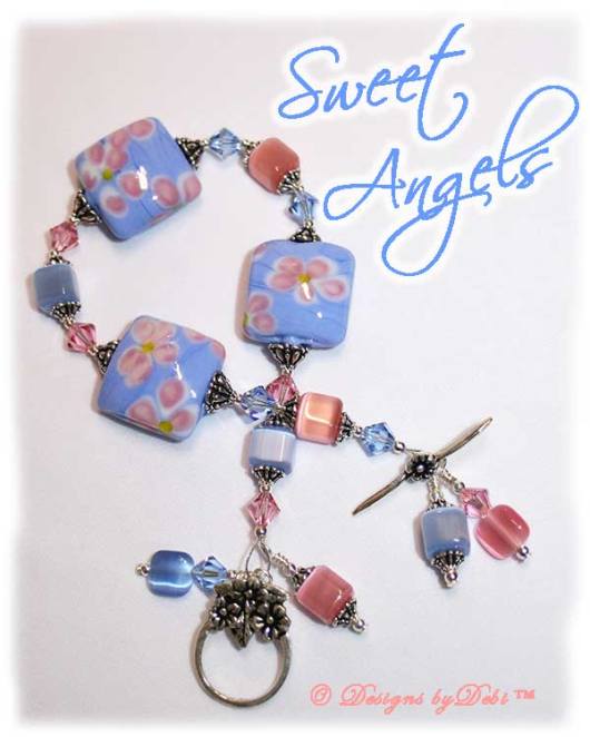 Designs by Debi Handmade Jewelry Sweet Angels one of a kind ooak handmade light pink and light blue lampwork and crystal bracelet made in honor of national pregnancy and infant loss awareness month to raise money for Missing GRACE Foundation. It was made with pink flowers on blue handmade square lampwork beads, pink and blue cat's eye beads, pink and blue crystals and sterling silver with a flower toggle clasp.