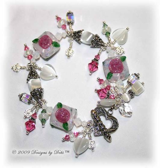 Roses on the Glistening Snow Handmade Bracelet made with artisan handmade lampwork beads, Bali silver, Swarovski crystal, and cat's eye with a toggle style clasp.