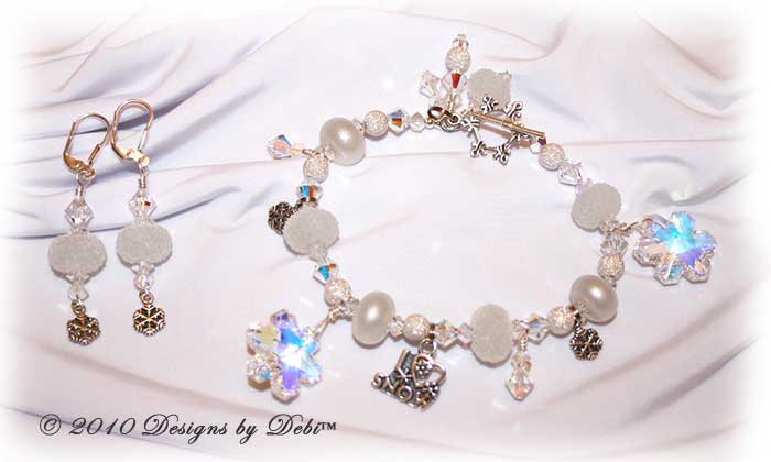 I Love Snow Handmade Bracelet and Earrings Set made with sugar and pixie white artisan handmade lampwork beads, sterling silver snowflakes and Swarovski crystal snowflakes and simplicity and bicones with a sterling silver snowflake toggle style clasp.