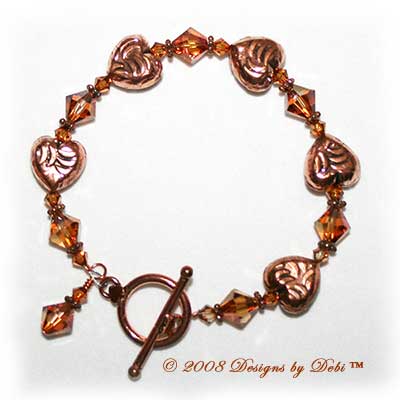 Designs by Debi Handmade Jewelry Copper Embossed Hearts and Swarovski Crystal Copper Bicones Bracelet with a Copper Round Toggle Clasp