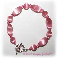 Designs by Debi Handmade Jewelry Pink Cat's Eye Twist and Round and Swarovski Crystal Rose Bicones Bracelet with a Silver Round Toggle Clasp