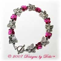 Designs by Debi Handmade Jewelry Silver and Swarovski Crystal Fuchsia Butterflies Bracelet with a Silver Round Toggle Clasp