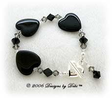 Designs by Debi Handmade Jewelry Black Glass Hearts and Swarovski Crystal Jet, Black Diamond and Crystal Bicones Bracelet with a Silver Heart Toggle Clasp