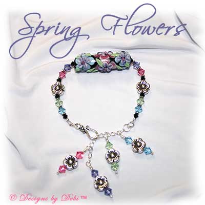 Designs by Debi Handmade Jewelry Spring Flowers Handmade Floral Lampwork Barrel Bead, Swarovski Crystal Tanzanite, Rose, Chrysolite, Aquamarine and Jet Bicones and Sterling Silver Flower Beads Bracelet with a Sterling Silver Hook Clasp and Extender Chain with Dangles ~ OOAK