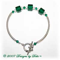 Designs by Debi Handmade Jewelry Sterling Silver Swarovski Crystal Emerald Cubes and Bicones and Crystal Spacers Curved Tube Bracelet with a Sterling Silver Claddagh Toggle Clasp