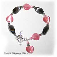 Designs by Debi Handmade Jewelry Gray Twist and Pink Hearts Cat's Eye Beads and Swarovski Crystal Black Diamond and Light Rose Bicones Bracelet with a Sterling Silver Heart Toggle Clasp
