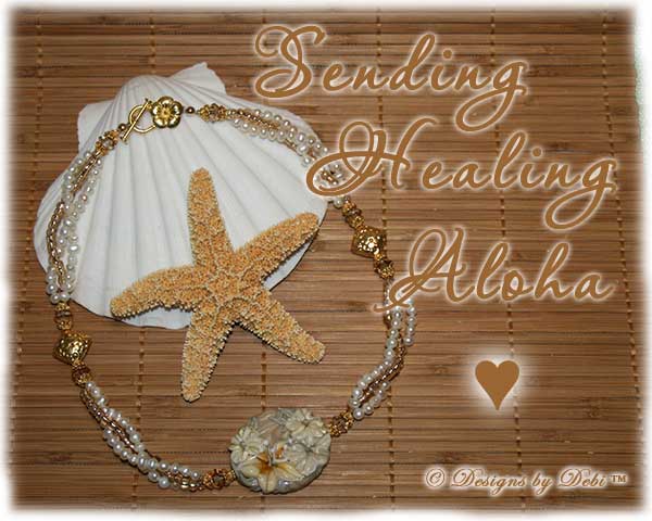 Designs by Debi Handmade Jewelry for Charity Necklace Sending Healing Aloha. A one of a kind ooak hibiscus lampwork necklace with freshwater pearls, gold beads, Bali floral pillow beads and a gold hibiscus toggle clasp.