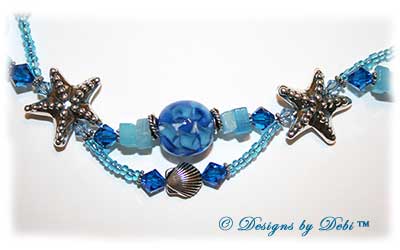 Designs by Debi Jewelry for Charity Piece for August 2010 to raise money for The Donald Paterson Recovery Fund. A one-of-a-kind artisan handmade bracelet with blue ribbon waves round handmade glass beads, thai silver starfish beads, swarovski crystal aquamarine and capri blue bicones, bali sterling silver spacer beads, sterling silver conch shells, tierracast silver scallop shells, light blue cat's eye chips, seed beads and a bali sterling silver hook and eye clasp with extender chain. OOAK one of a kind