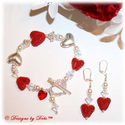 Designs by Debi Handmade Jewelry for Charity one-of-a-kind Lampwork Jewelry Set Romantic Victorian Valentine. Bracelet and Earrings set with red lampwork hearts, Bali sterling silver hearts, Swarovski crystal ab bicones, white Swarovski pearls, a Swarovski crystal red heart and a delicate sterling silver filigree heart toggle clasp. ooak