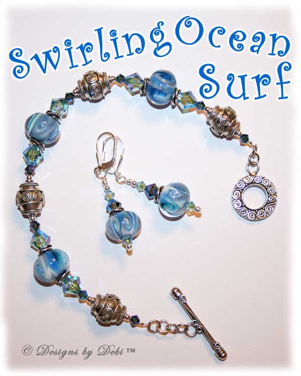 Designs by Debi Jewelry for Charity Set July 2011 Swirling Ocean Surf to benefit the American Red Cross. A beautiful, one of a kind handmade lampwork bracelet and earrings set in swirling blue, white and hints of green, swirled Bali silver beads, twisted rings and elegantly scrolled toggle clasp accented with Swarovski crystal bicones in aquamarine ab2x and montana ab2x. OOAK © Designs by Debi All Rights Reserved