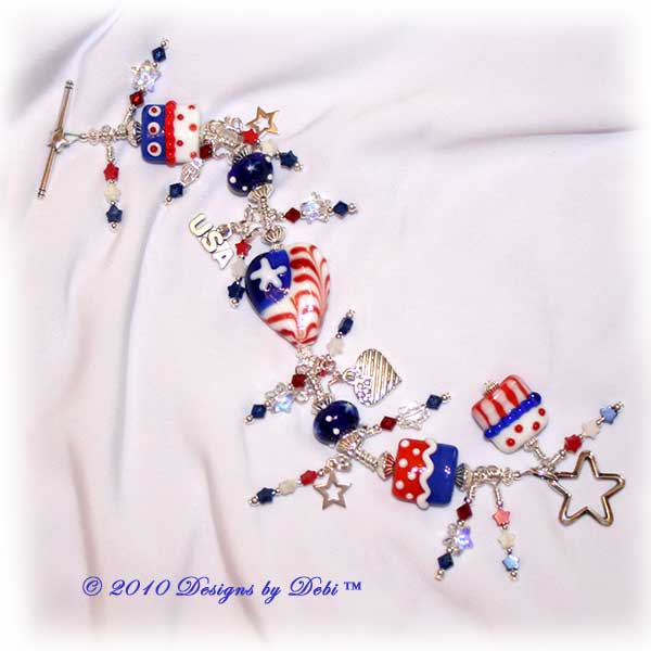 Designs by Debi Jewelry for Charity Piece for June 2010 to raise money for Soldiers' Angels. A one-of-a-kind artisan handmade bracelet with red, white and blue flag motif handmade glass beads, swarovski crystal siam and dark sapphire bicones, Swarovski Crystal and Crystal AB stars, red, white and blue howlite stars, sterling silver star, heart-shaped flag and USA charms and a sterling silver star toggle clasp. OOAK