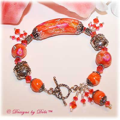 Can't Wait for Spring! Designs by Debi Jewelry for Charity Bracelet March 2011 A fun, one of a kind handmade bracelet of orange, pink and white polymer clay beads with flowers and dragonflies, Bali silver beads, Swarovski crystals and sterling silver. OOAK