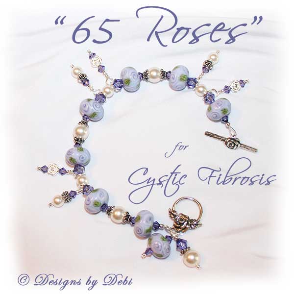 Designs by Debi Jewelry for Charity Piece for May 2010 to raise money for The Cystic Fibrosis Foundation. A one-of-a-kind artisan handmade bracelet with round handmade glass beads adorned with purple roses and green leaves, swarovski crystal tanzanite bicones, white swarovski pearls, sterling silver rose beads, sterling silver rose spacer beads and a sterling silver roses toggle clasp. OOAK