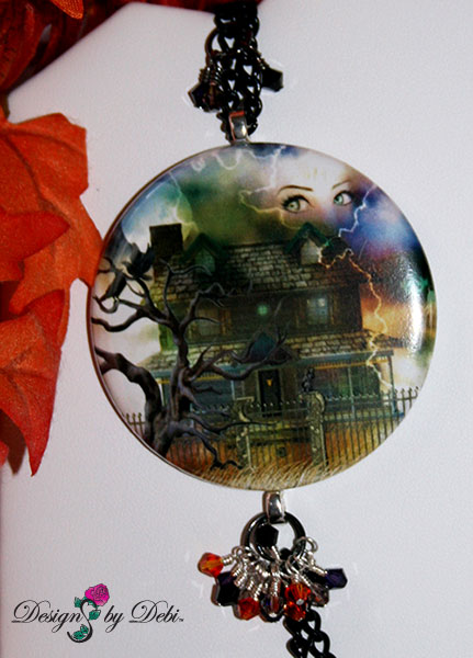Focal Piece of Designs by Debi Handmade Jewelry for Charity Set October 2012 to benefit Born This Way Foundation. A one of a kind Halloween theme lariat necklace and earrings made with Swarovksi and other crystals in black, black diamond, fire opal and purple velvet, a unique Haunted House focal piece, black curb chain, a white glass ghost, haunted house, spider web and padlock charms, a white glass bone pendant bead and a large silver skeleton key. Copyright Designs by Debi.