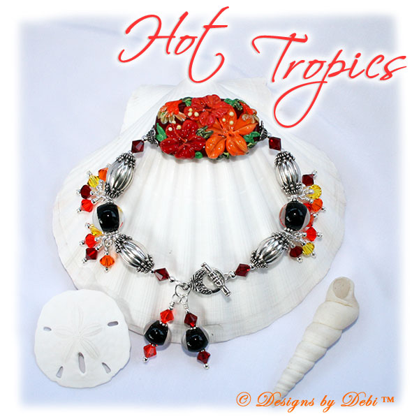 Designs by Debi Handmade Jewelry for Charity Piece for September 2010 to raise money for Stand Up To Cancer. A one-of-a-kind artisan handmade bracelet with an oblong hibiscus focal in reds and oranges, clear-encased black handmade glass beads, bali sterling silver fluted granulated oval beads, swarovski crystal siam red, hyacinth orange, sun light orange and citrine yellow bicones, bali sterling silver spacer beads, sterling silver seamless round beads, two large dangles and a bali sterling silver granulated detail toggle clasp. OOAK one of a kind