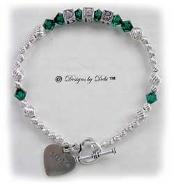 Designs by Debi Handmade Jewelry Personalized Keepsake Bracelet in the Karen Style Twist bead combination with Emerald (May) crystals, a heart toggle clasp and Mom heart charm. Mother's Bracelet