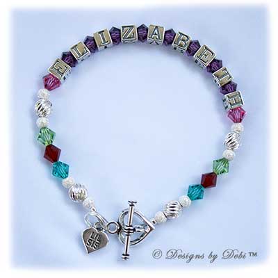 Designs by Debi Handmade Jewelry Family Keepsake Bracelet in the Karen Style Twist and Stardust bead combination with every family member's birthstone, a heart toggle and Lil Sis heart charm. Mother's Bracelet