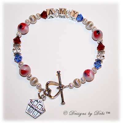 Designs by Debi Handmade Jewelry Personalized Remember 9/11 Bracelet Amy with red, white and blue Swarovski crystals, sterling silver and fiber optic flag beads, a heart toggle clasp and Remember charm with the Twin Towers and stars.
