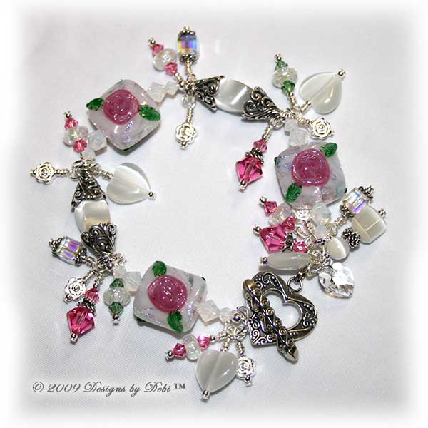 Roses on the Glistening Snow Handmade Bracelet made with artisan handmade lampwork beads, Bali silver, Swarovski crystal, and cat's eye with a toggle style clasp.