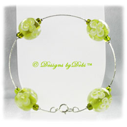 Designs by Debi Handmade Jewelry Aloha Collection Lime Green Silver Bangle Bracelet featuring lime green aloha floral glass beads, lime green seed beads and a spring ring clasp.