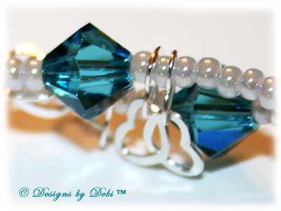 Designs by Debi Handmade Jewelry January 2011 Jewelry for Charity Piece Caribbean Hearts. Teal, white and sterling silver one of a kind lampwork bracelet to raise money for the National Cervical Cancer Coalition. The bracelet has a heart theme...handmade lamwork beads swit=rled in white and caribbean blues, swarovski teal indicolite bisone crystals, tiny pearly white seed beads, round Bali beads with a repeating heart design, sterling silver heart link chain and a sterling silver heart toggle. OOAK