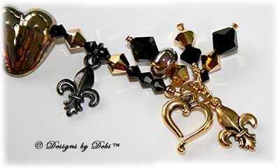 Designs by Debi Handmade Jewelry for Charity Set June 2011 The Spirit and Strength of Who Dat Nation. A one of a kind bracelet and earrings set featuring gold handmade lampwork hearts and spacers, black and gold fleur de lis charms, jet black and crystal gold aurum 2x biicnes and a gold jubilee heart toggle clasp. It will benefit The Brees Dream Foundation. OOAK one-of-a-kind