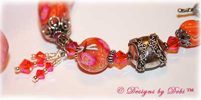 Can't Wait for Spring! Designs by Debi Jewelry for Charity Bracelet March 2011 A fun, one of a kind handmade bracelet of orange, pink and white polymer clay beads with flowers and dragonflies, Bali silver beads, Swarovski crystals and sterling silver. OOAK