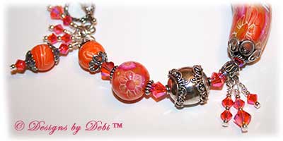 Can't Wait for Spring! Designs by Debi Jewelry for Charity Bracelet March 2011 A fun, one of a kind handmade bracelet of orange, pink and white polymer clay beads with flowers and dragonflies, Bali silver beads, Swarovski crystals and sterling silver. OOAK