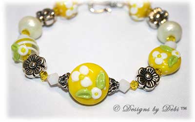 Designs by Debi Handmade Jewelry for Charity Bracelet and Earrings Set Hope for a Bright Future. The one of a kind ooak bracelet features handmade artisan lampwork glass beads, sterling silver flower beads, Swarovski citrine and white alabaster bicones, a sterling silver hook clasp and extender chain with charms. The one of a kind earrings are leverback style with matching beads, crystals and chain.