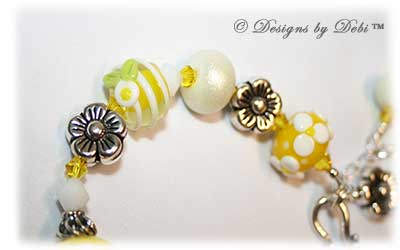 Designs by Debi Handmade Jewelry for Charity Bracelet and Earrings Set Hope for a Bright Future. The one of a kind ooak bracelet features handmade artisan lampwork glass beads, sterling silver flower beads, Swarovski citrine and white alabaster bicones, a sterling silver hook clasp and extender chain with charms. The one of a kind earrings are leverback style with matching beads, crystals and chain.