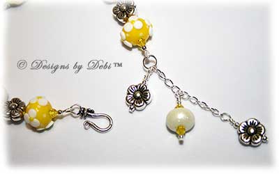 Designs by Debi Handmade Jewelry for Charity Bracelet and Earrings Set Hope for a Bright Future. The one of a kind ooak bracelet features handmade artisan lampwork glass beads, sterling silver flower beads, Swarovski citrine and white alabaster bicones, a sterling silver hook clasp and extender chain with charms. The one of a kind earrings are leverback style with matching beads, crystals and chain.