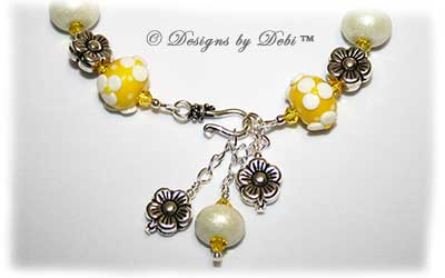Designs by Debi Handmade Jewelry for Charity Bracelet and Earrings Set Hope for a Bright Future. The one of a kind ooak bracelet features handmade artisan lampwork glass beads, sterling silver flower beads, Swarovski citrine and white alabaster bicones, a sterling silver hook clasp and extender chain with charms. The one of a kind earrings are leverback style with matching beads, crystals and chain.