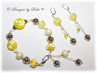 Designs by Debi Handmade Jewelry for Charity Bracelet and Earrings Set Hope for a Bright Future. The one of a kind ooak bracelet features handmade artisan lampwork glass beads, sterling silver flower beads, Swarovski citrine and white alabaster bicones, a sterling silver hook clasp and extender chain with charms. The one of a kind earrings are leverback style with matching beads, crystals and chain.